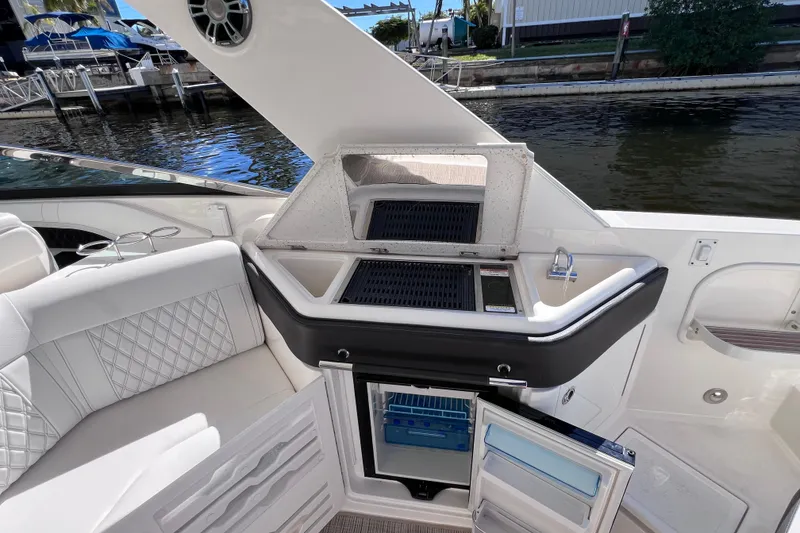 Slide: The Image of 2019 Sea Ray SLX 310 Outboard interior with sleek seating and modern amenities. - 25