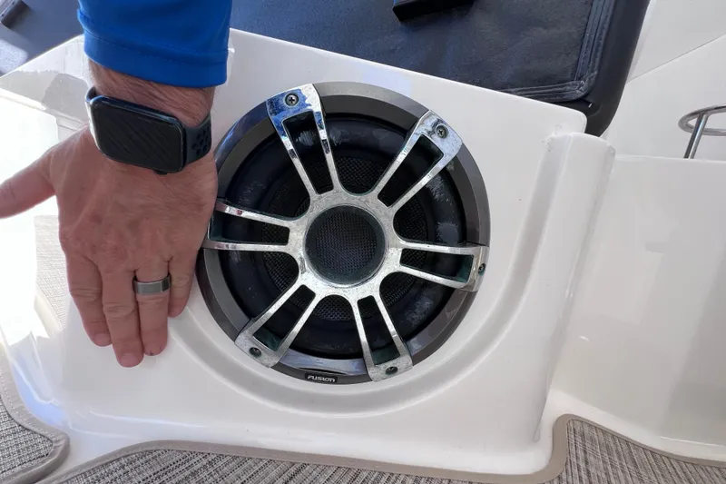 Slide: The Image of Hand measuring speaker on 2019 Sea Ray SLX 310 Outboard boat. - 33