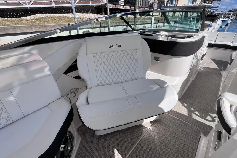 Slide: The Image of 2019 Sea Ray SLX 310 Outboard boat interior with luxurious white seating. - 37