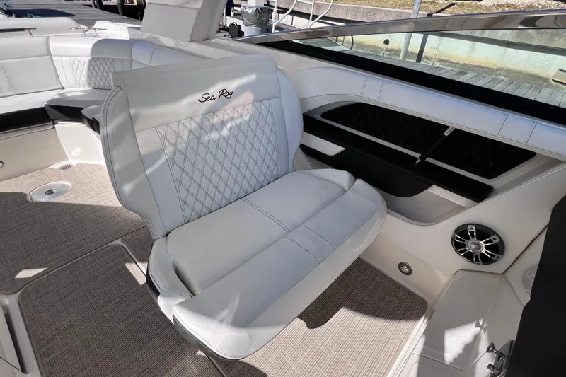 Slide: The Image of 2019 Sea Ray SLX 310 Outboard interior with luxurious white seating and modern design. - 38