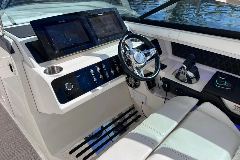 Slide: The Image of Luxurious white seating on 2019 Sea Ray SLX 310 Outboard boat interior. - 42