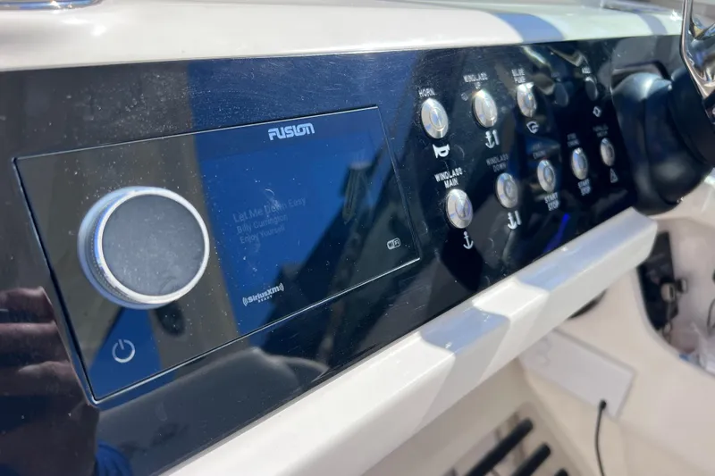 Slide: The Image of 2019 Sea Ray SLX 310 Outboard helm with dual Simrad displays and modern controls. - 44