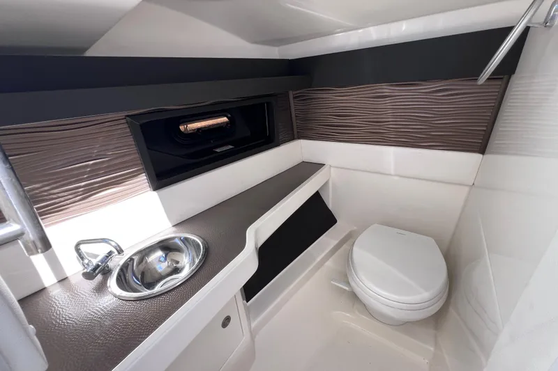 Slide: The Image of 2019 Sea Ray SLX 310 Outboard boat interior with sleek design and modern amenities. - 56