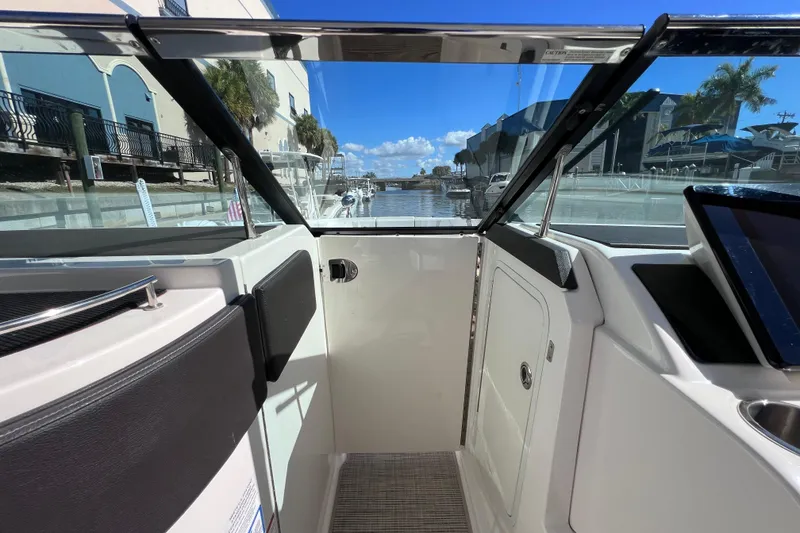 Slide: The Image of Control panel of 2019 Sea Ray SLX 310 Outboard waste system with keys inserted. - 58