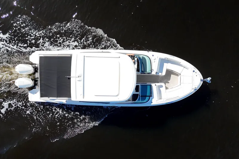 Slide: The Image of 2019 Sea Ray SLX 310 Outboard on open water, featuring dual engines. - 6