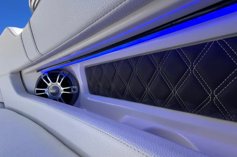 Slide: The Image of 2019 Sea Ray SLX 310 Outboard boat interior with sleek white seating and table. - 64