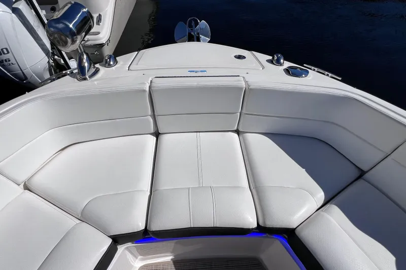Slide: The Image of 2019 Sea Ray SLX 310 Outboard interior with speaker and blue LED lighting. - 65