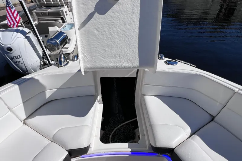 Slide: The Image of 2019 Sea Ray SLX 310 Outboard boat with white cushioned seating and sleek design. - 67