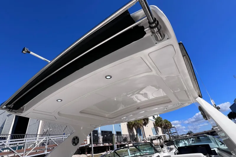 Slide: The Image of 2019 Sea Ray SLX 310 Outboard boat with spacious white seating and elegant design. - 71