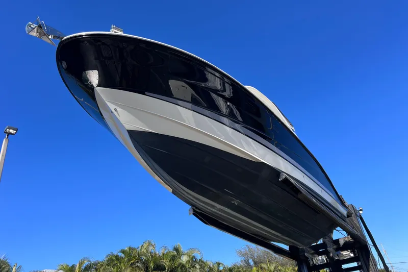 Slide: The Image of 2019 Sea Ray SLX 310 Outboard boat on forklift, clear blue sky background. - 84