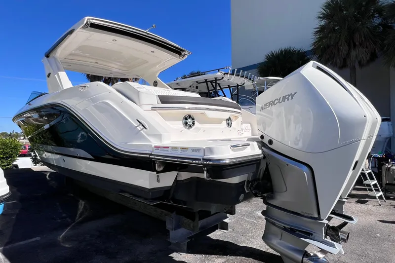 Slide: The Image of 2019 Sea Ray SLX 310 Outboard boat on display under clear blue sky. - 87