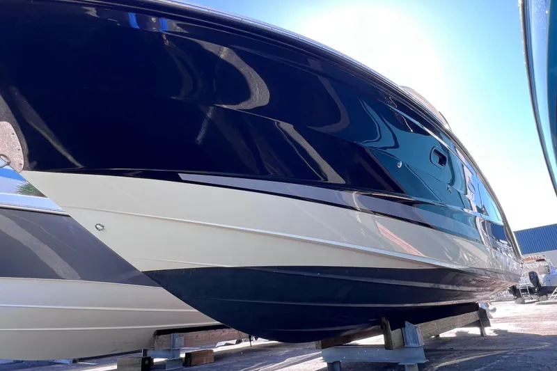 Slide: The Image of 2019 Sea Ray SLX 310 Outboard boat hull, displayed outdoors on a sunny day. - 89