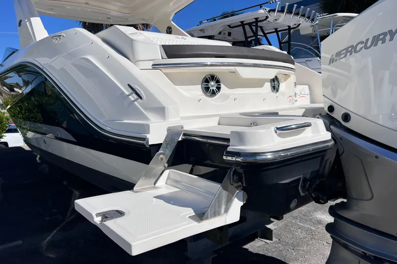 Slide: The Image of 2019 Sea Ray SLX 310 Outboard boat on display, showcasing sleek hull design. - 90