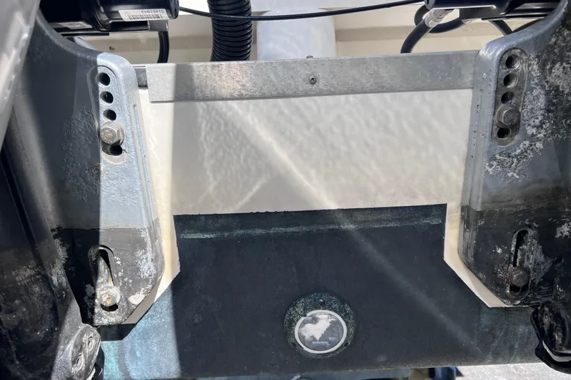 Slide: The Image of Close-up of 2019 Sea Ray SLX 310 Outboard engine mount with visible wear and corrosion. - 92