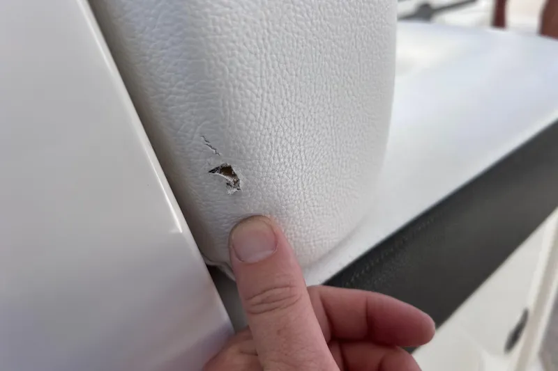 Slide: The Image of Damaged upholstery on 2019 Sea Ray SLX 310 Outboard boat seat. - 96