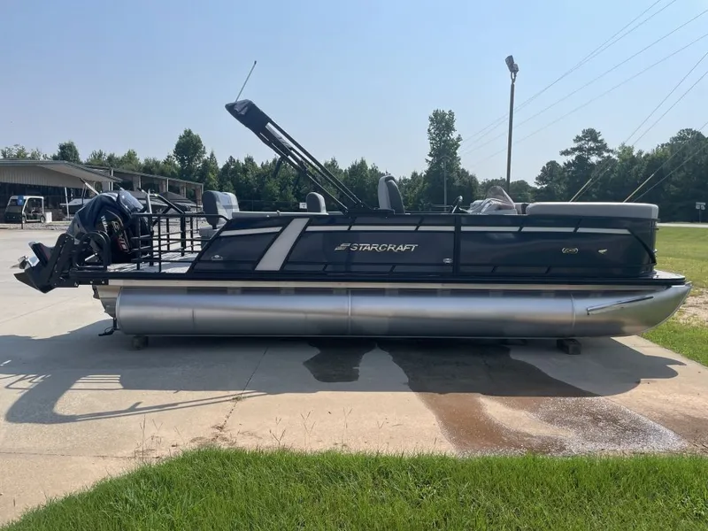Slide: The Image of A modern pontoon boat by Starcraft, model EXS 3 Q DH, sits on an outdoor concrete area. - 3