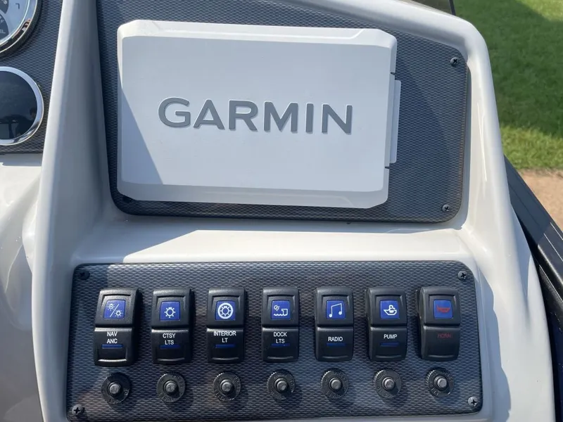 Slide: The Image of The image shows a helm console with a Garmin device and several switches for various functions. - 8