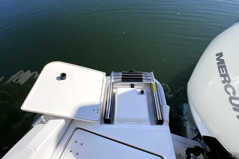 Slide: The Image of 2023 Boston Whaler 220 Dauntless boat docked at marina, side view. - 11