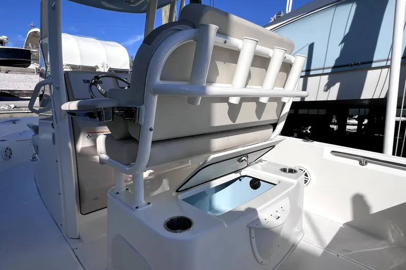 Slide: The Image of 2023 Boston Whaler 220 Dauntless boat interior with seating and Mercury engine. - 15