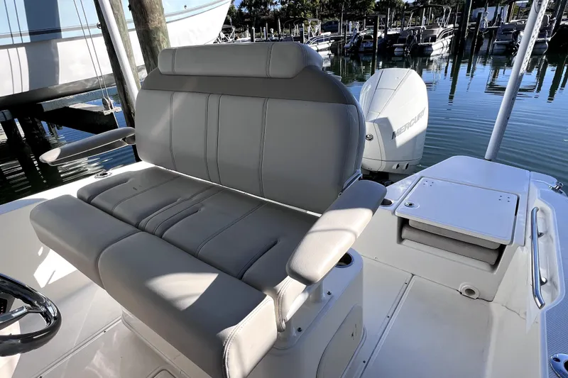 Slide: The Image of 2023 Boston Whaler 220 Dauntless boat with sleek white top and seating area. - 17