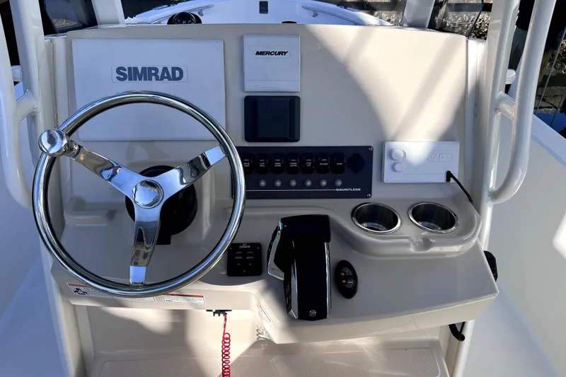 Slide: The Image of 2023 Boston Whaler 220 Dauntless boat interior with seating and Mercury engine. - 19