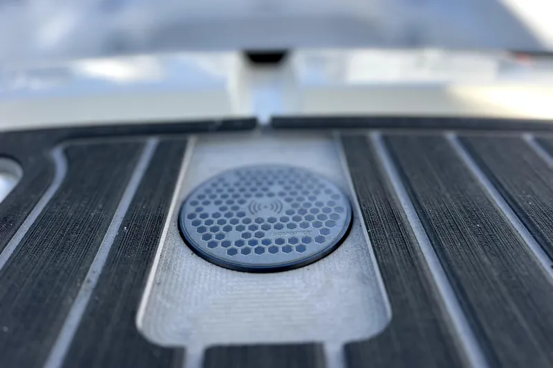 Slide: The Image of 2023 Boston Whaler 220 Dauntless boat interior, featuring helm and seating area at dock. - 25