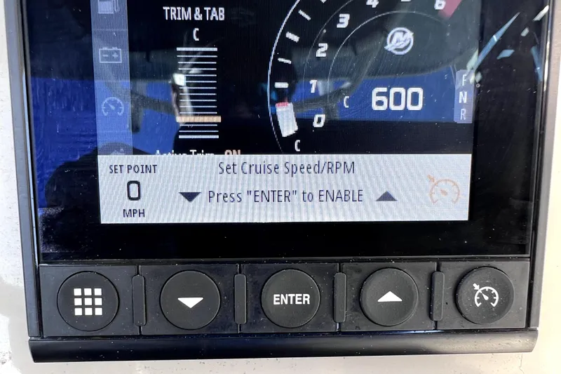 Slide: The Image of 2023 Boston Whaler 220 Dauntless boat seat with Mercury engine in marina setting. - 29