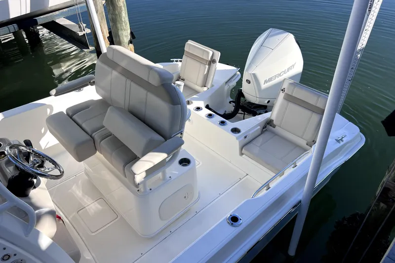Slide: The Image of 2023 Boston Whaler 220 Dauntless boat cruising on a calm waterway. - 4