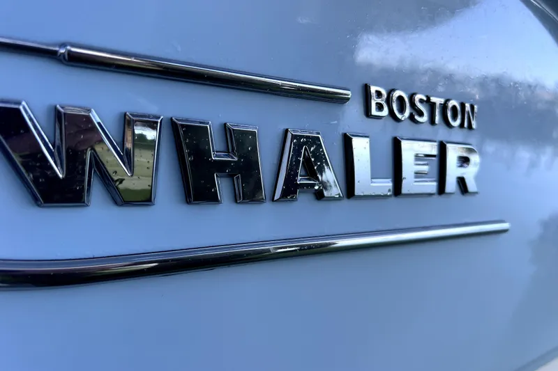 Slide: The Image of 2023 Boston Whaler 220 Dauntless boat cruising on a calm waterway. - 5