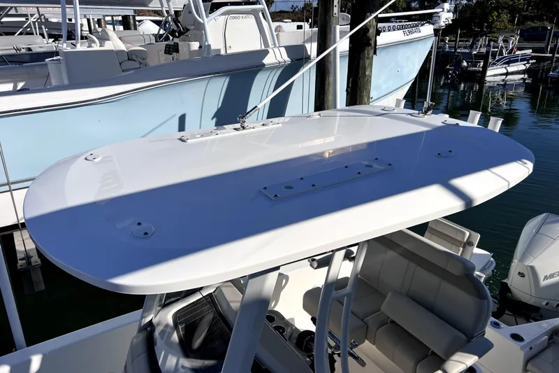 Slide: The Image of 2023 Boston Whaler 220 Dauntless boat cruising on a calm waterway. - 6