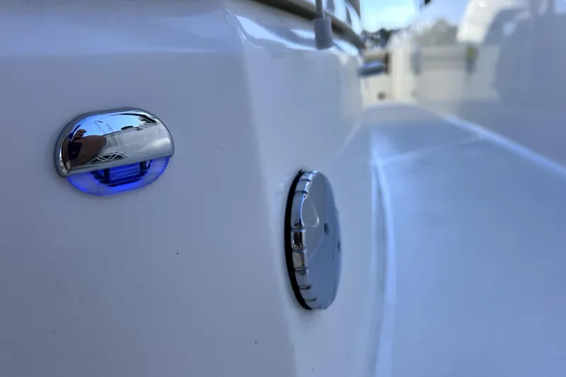 Slide: The Image of Close-up of 2023 Boston Whaler 220 Dauntless boat detail with blue light. - 64