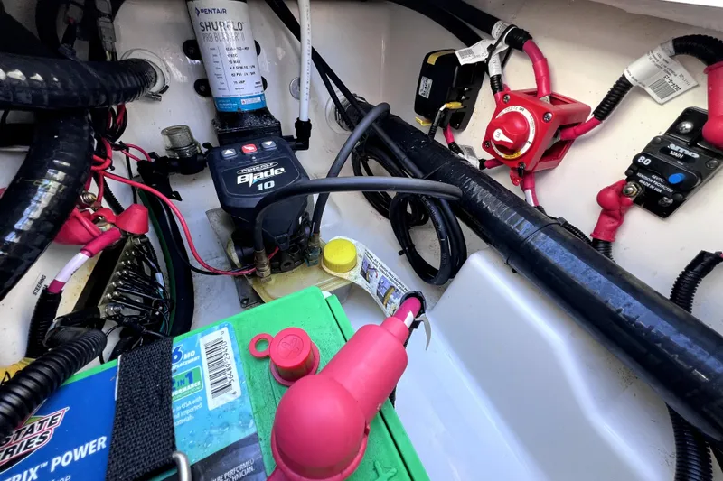 Slide: The Image of 2023 Boston Whaler 220 Dauntless boat wiring and battery compartment. - 66