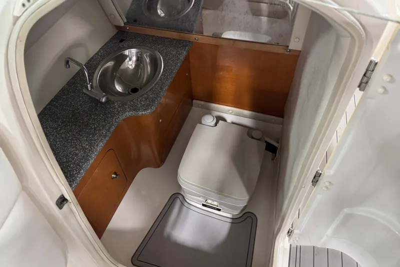 Slide: The Image of 2007 Chaparral 256 SSi boat bathroom with sink and portable toilet. - 11