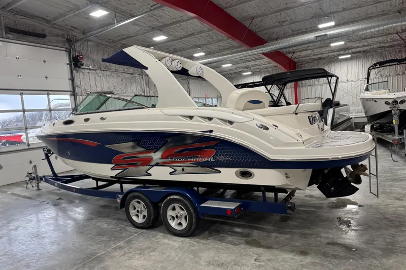 Slide: The Image of 2007 Chaparral 256 SSi boat in a garage, featuring sleek design and vibrant graphics. - 3
