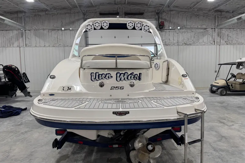 Slide: The Image of 2007 Chaparral 256 SSi boat in garage, rear view with "Uno Más!" text. - 4