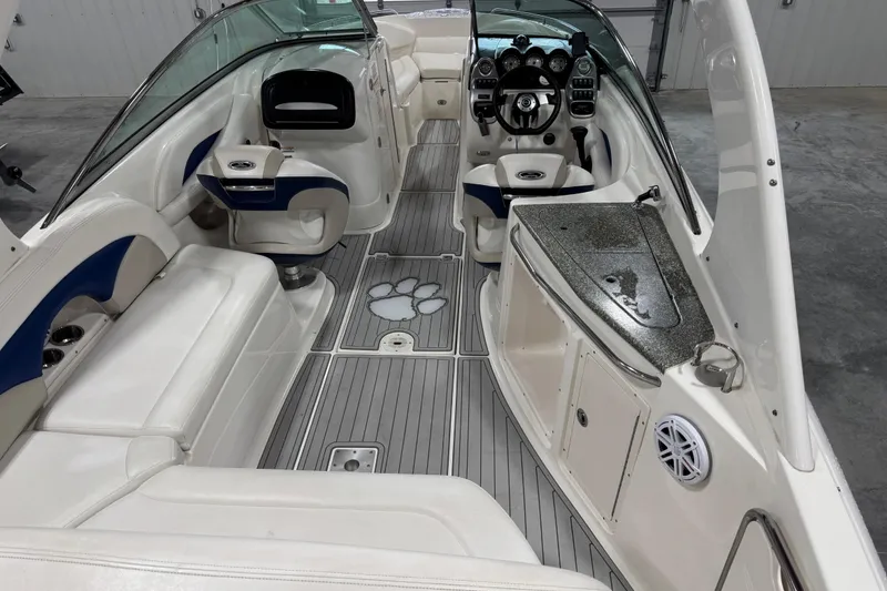 Slide: The Image of 2007 Chaparral 256 SSi boat interior with white seating and modern dashboard. - 6
