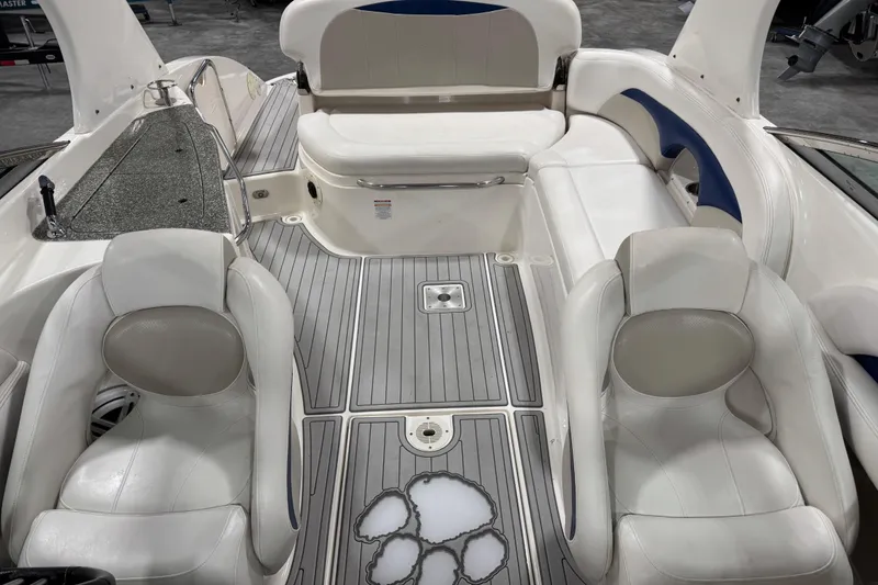 Slide: The Image of 2007 Chaparral 256 SSi boat interior with white seating and gray flooring. - 7