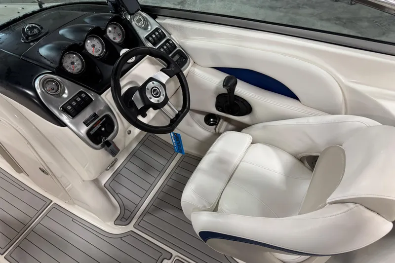 Slide: The Image of 2007 Chaparral 256 SSi boat interior with steering wheel and dashboard controls. - 9