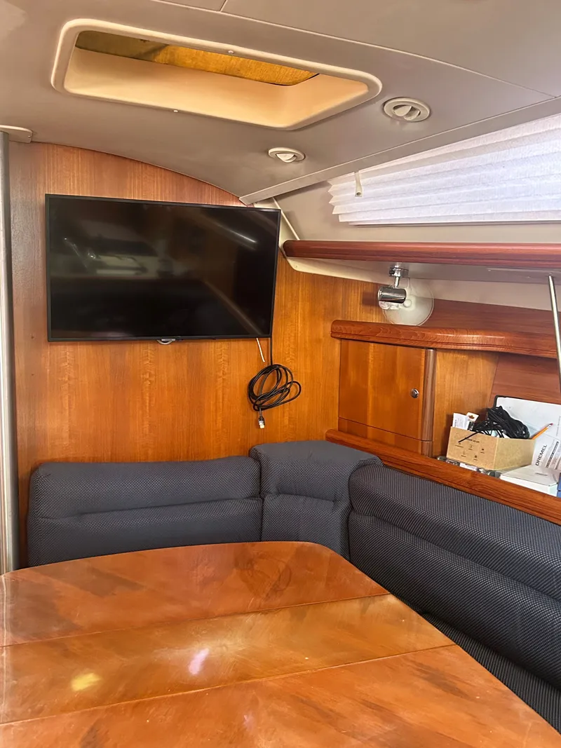 Slide: The Image of Interior of a 2006 Hunter 38 Ft Sloop with TV and seating area. - 30