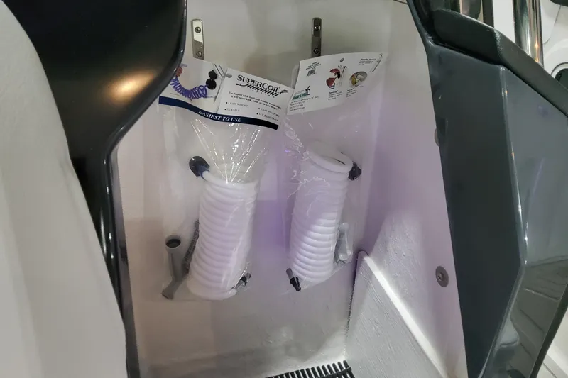 Slide: The Image of Storage area with coiled hoses on a 2026 Formula 360 Crossover Bowrider OB. - 23