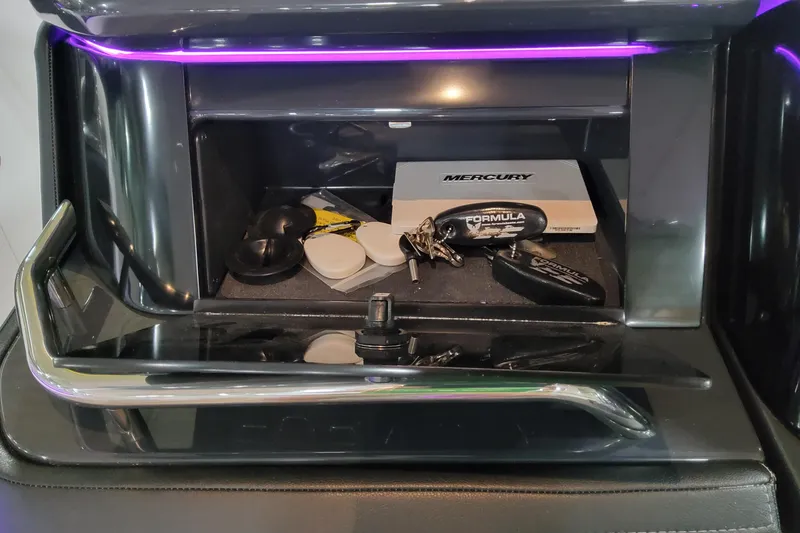 Slide: The Image of 2026 Formula 360 Crossover Bowrider OB dashboard compartment with keys and manual. - 24