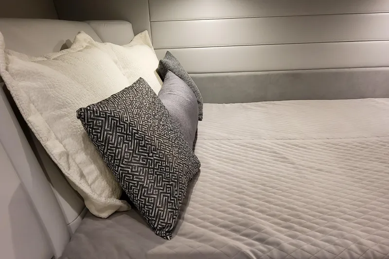 Slide: The Image of Luxurious bedding with patterned pillows in the 2026 Formula 360 Crossover Bowrider OB cabin. - 34