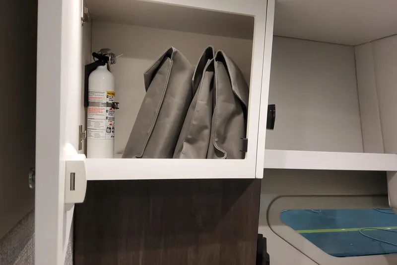 Slide: The Image of Cabinet storage in 2026 Formula 360 Crossover Bowrider OB with fire extinguisher and bags. - 39