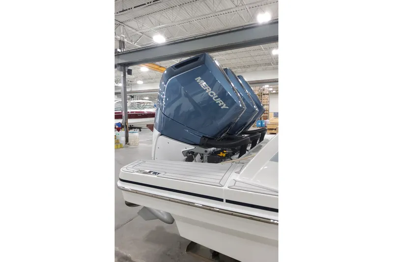 Slide: The Image of 2026 Formula 360 Crossover Bowrider OB with Mercury outboard engines in a showroom. - 8