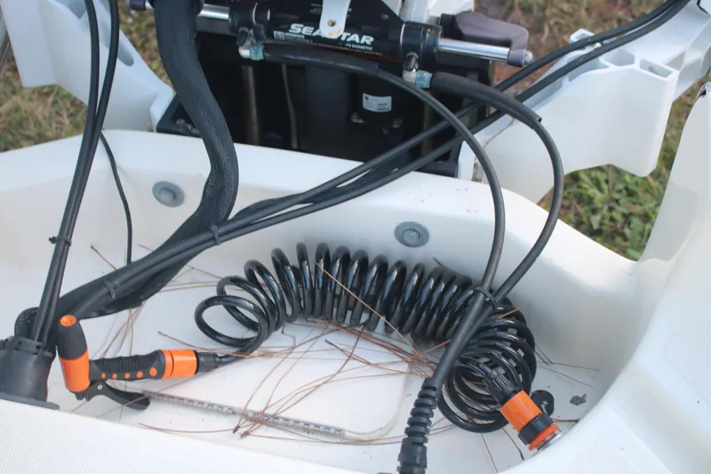 Slide: The Image of Coiled hose and cables on 2022 Pioneer 220 Bay Sport boat deck. - 12