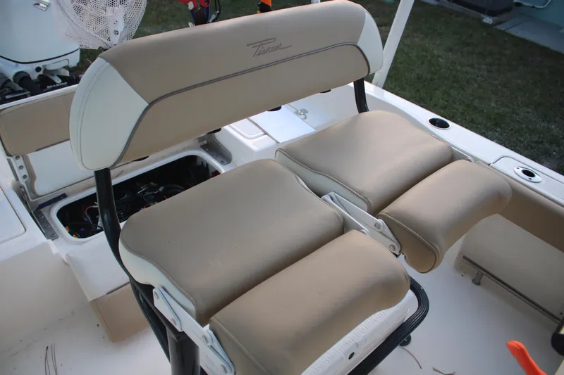Slide: The Image of Pioneer 220 Bay Sport 2022 boat seating with beige cushions and storage compartments. - 13