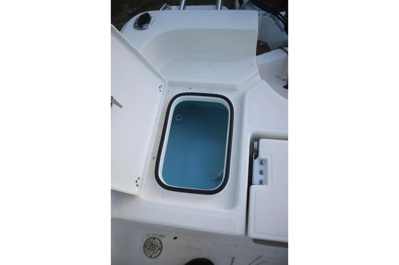 Slide: The Image of Open storage compartment on 2022 Pioneer 220 Bay Sport boat. - 17