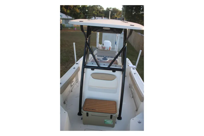 Slide: The Image of 2022 Pioneer 220 Bay Sport boat interior with T-top and seating. - 21