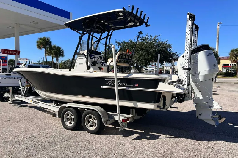 Slide: The Image of 2022 Pioneer 220 Bay Sport boat on trailer at gas station, sunny day. - 4