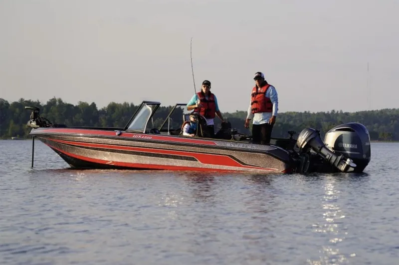 Slide: The Image of Manufacturer Provided Image: 2025 Skeeter WX2200 boat with anglers fishing on a calm lake. - 10